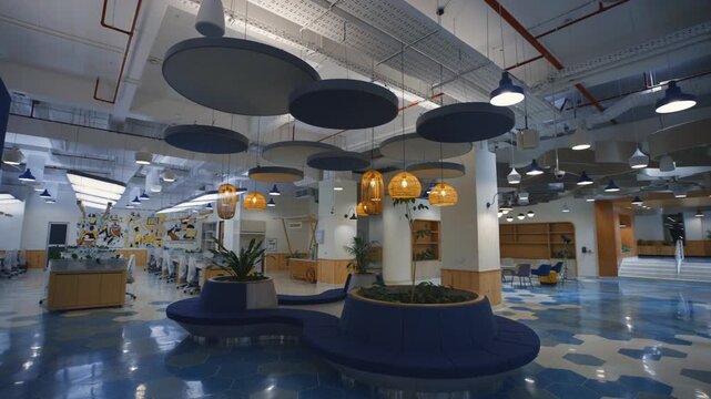 Open office lounge with circular bench planters acoustic disc baffles and hexagonal floor