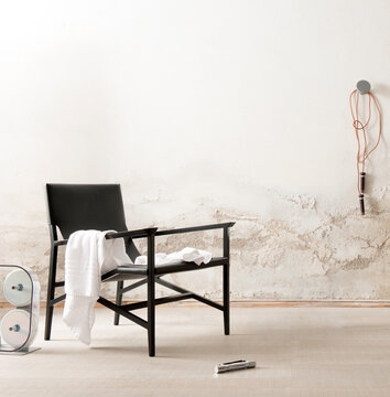Single shot photo of a room with a black armchair
