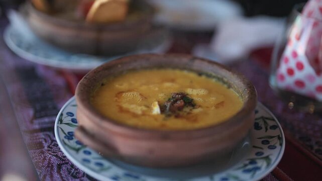 Traditional Andean humita gently simmers in a clay bowl, showcasing a creamy corn preparation rooted in regional culinary traditions, close up food shot.