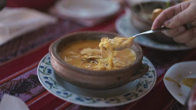Traditional humita is served from a clay bowl, revealing a creamy corn texture and authentic Andean culinary heritage, slow motion close up food shot.