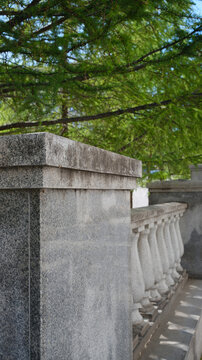 Classic stone balustrade with concrete balusters in a historic city. Architectural gray background with classic decorative railings on the terrace.