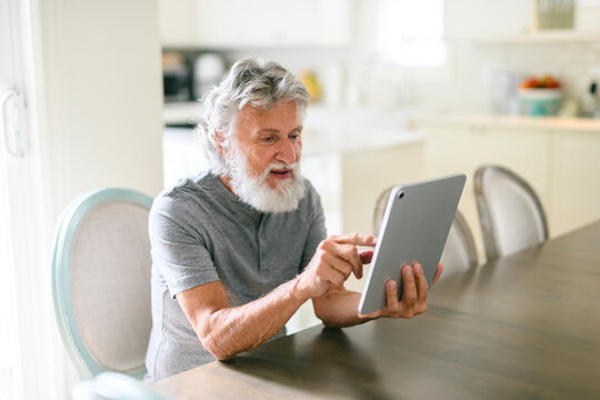 senior men having great time at home using tablet