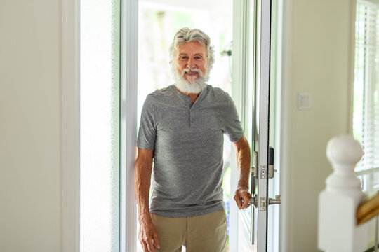 senior men having great time enter on his house by the fornt door