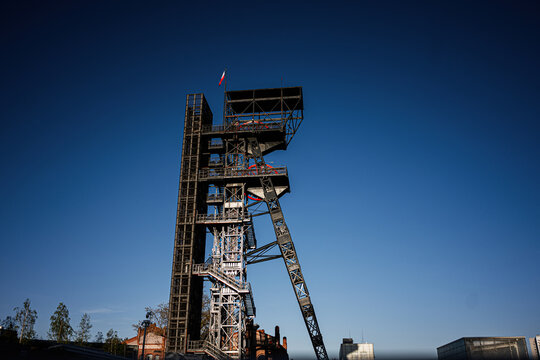 Historic steel mining headframe and industrial tower in Katowice, Poland, iconic Silesian industrial heritage under a clear blue sky