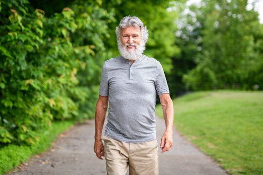 Senior man walk in the forest on a summer day