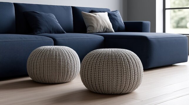 Modern living room interior with navy blue modular sofa and textured knit poufs