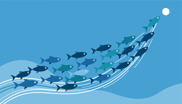 Large school of blue fish swimming upward together in wave formation towards bright light in deep ocean.