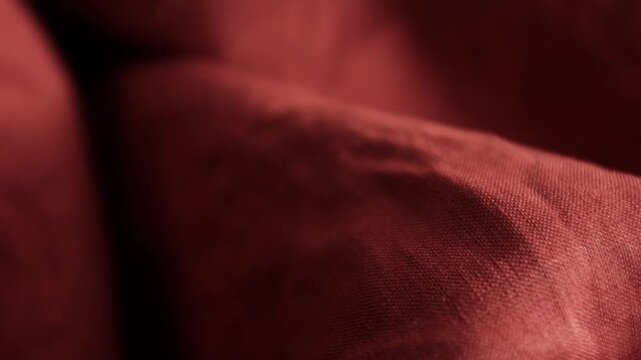 Premium terracotta red linen or hemp fabric texture. Rustic wrinkles, natural organic pattern, and rich earthy red tones. Ideal for abstract textile design, slow fashion concepts, eco-friendly apparel