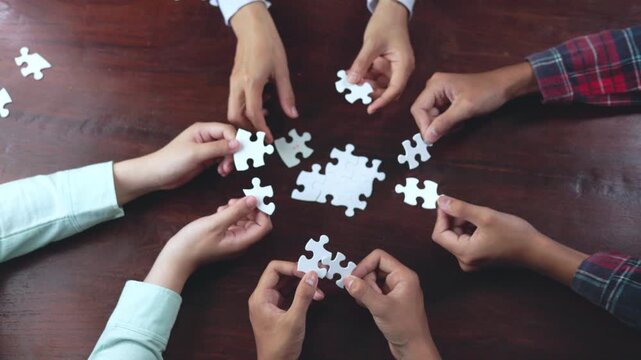 Professional business meeting with a team connecting puzzle pieces. Collaboration, leadership, strategy, business success, organization, communication, workplace, 4K.
