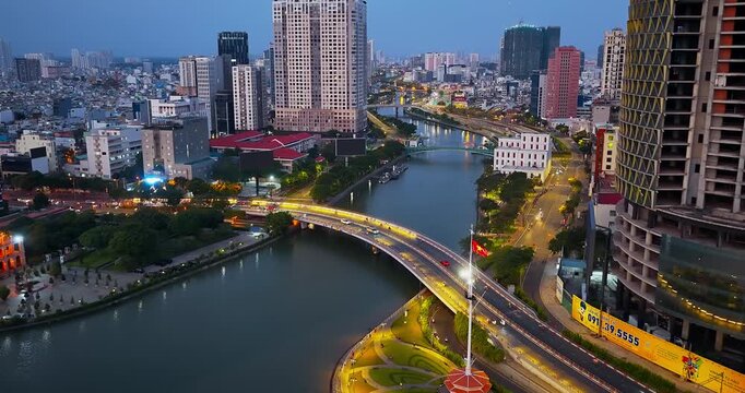 Beautiful view of Vo Van Kiet Boulevard in Ho Chi Minh City, Vietnam, featuring rows of blooming pink trumpet trees, vibrant urban scenery, flowing traffic, and the harmonious blend of nature