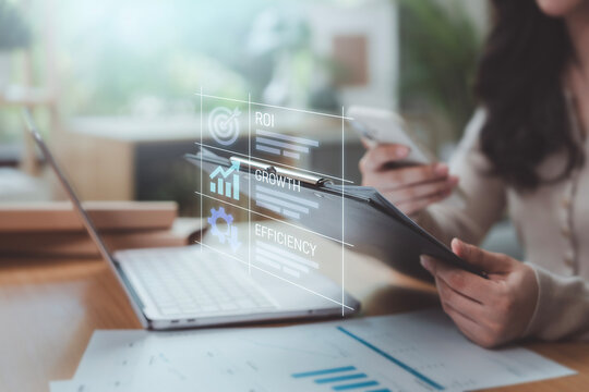 ROI growth cost efficiency concept woman analyzing data clipboard smartphone digital hologram target chart gear icons financial strategy business productivity performance optimization planning
