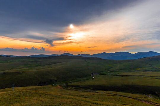 A spectacular mountain landscape sunset over the Bucegi Mountains along the high-altitude Transbucegi road in Romania