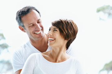 Fototapeta premium Love, laugh or couple outdoor with trip, healthy relationship or bonding together on summer holiday. Smile, mature man or woman in nature with care, romantic connection or happy moment on getaway.