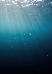 Obraz premium Abstract underwater blue background with light and particles