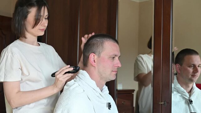 Woman Giving Her Husband a Buzz Cut at Home
