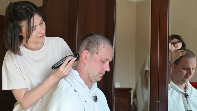 Woman Giving Her Husband a Buzz Cut at Home