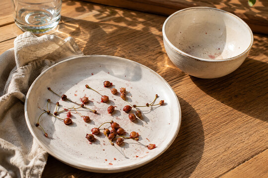 Cherry Pits on Empty Plate After Summer Snack