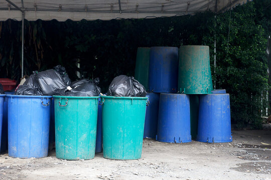 The garbage is wrapped in black bags and placed in a large plastic bin.