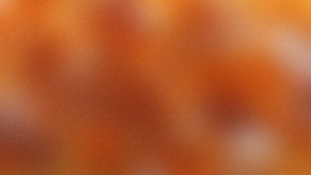 Abstract blurred background with warm orange and brown gradient tones.