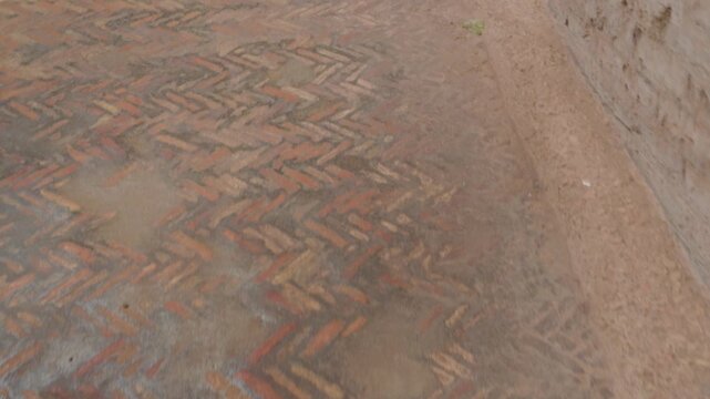 Ancient Roman Herringbone Brick Floor at Archaeological Site