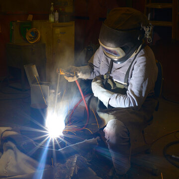A welder at work in an industrial plant 