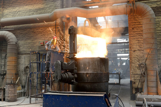 Workers at a melting furnace in an iron foundry