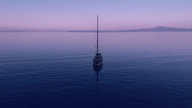 Anchored Sailboat on Calm Dawn Sea Near Verga and Kalamata, Greece, Wide Aerial View of Peaceful Yacht, Pastel Sky, Open Water, Mountain Coast and Mediterranean Bay