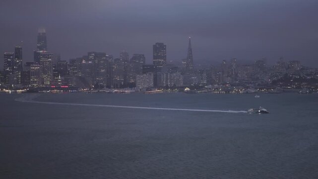 Passenger Ferry Wake Across San Francisco Bay at Dusk With Overcast Sky - Wide, Panning Shot