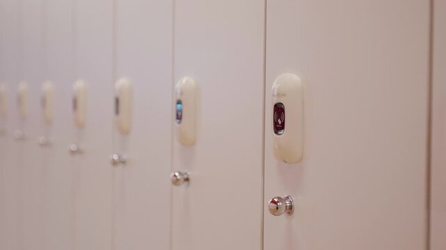 White lockers with electronic locks standing in a row