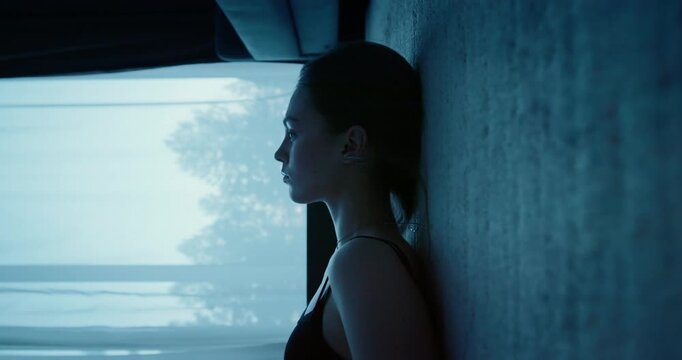 Woman silhouette in dark room. Sad girl lying on floor feel sorrow, loneliness. Melancholy mood, depression concept. Person in deep thought at night. Lonely reflecting thinking on life, solitude.