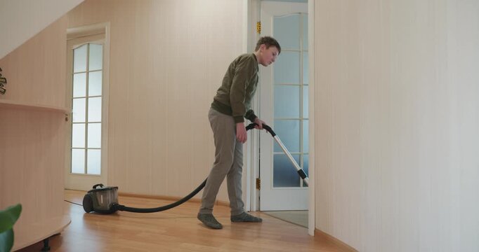 Caucasian Boy Kid Vacuum Hallway Corridor in House. 4K 10-bit