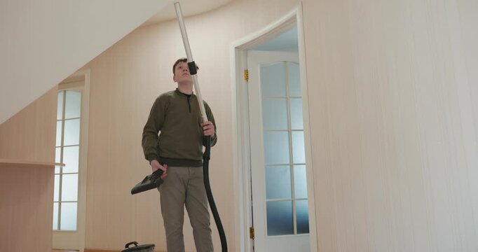 Caucasian Boy Kid Vacuum Hallway Corridor in House. 4K 10-bit