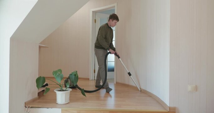 Caucasian Boy Kid Vacuum Hallway Corridor in House. 4K 10-bit