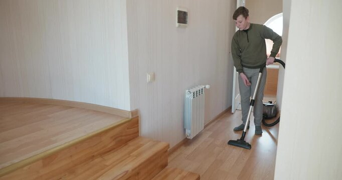 Caucasian Boy Kid Vacuum Hallway Corridor in House. 4K 10-bit