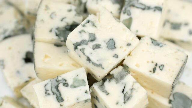 Blue cheese. Heap of sliced blue cheeses with a noble mold