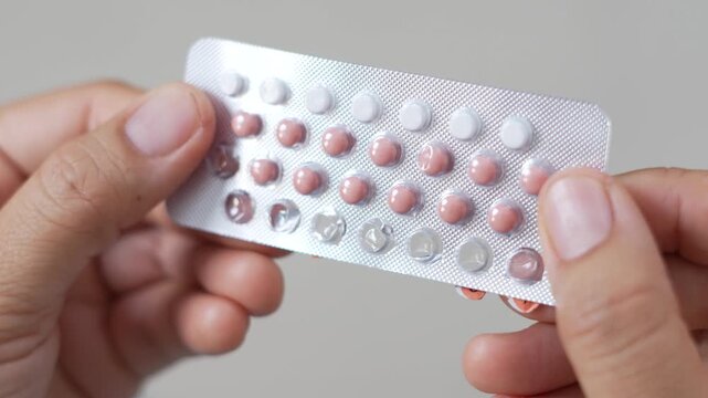 Close up woman hand contraceptive pill. Contraception reduces childbirth and pregnancy concept.