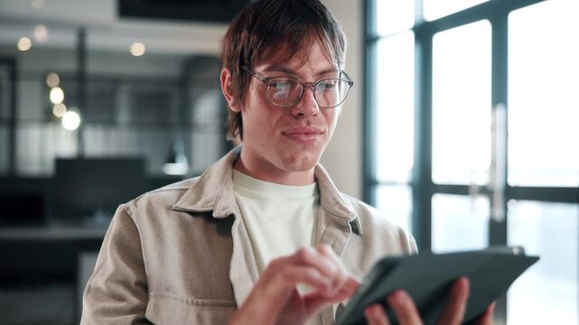 Smile, man and tablet with reading in office for publication revision, blog approval and editing. Creative, editor and scroll with tech at media agency for story review, grammar check and submission