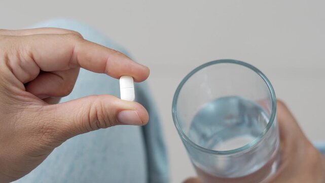 close up woman hand holding a medicine. Stop drug use Taking Medication Caring for the health care medical concept.