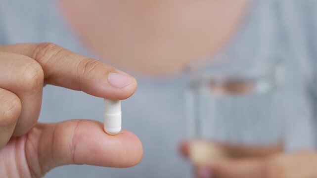 close up woman hand holding a medicine. Stop drug use Taking Medication Caring for the health care medical concept.