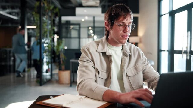 Business, man and typing on laptop in office for publication feedback, editing process and email. Creative, editor and tech at publishing agency for article comments, fact check story and submission