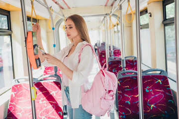 Profile portrait of nice young student girl smart phone pay buy ticket terminal travel commute public bus transport © deagreez