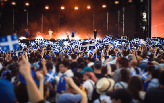 Quebec national birthday crowd holding lot of quebec flag