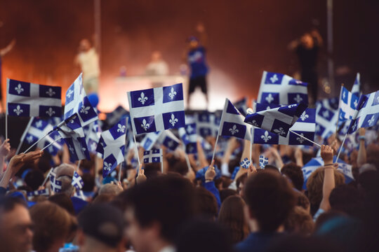 Quebec national birthday crowd holding lot of quebec flag