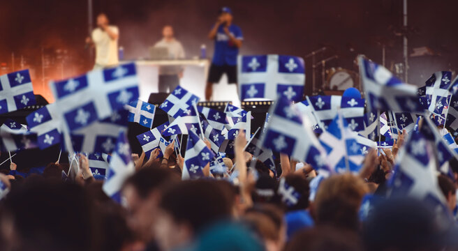 Quebec national birthday crowd holding lot of quebec flag