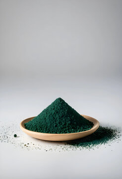 Pile of spirulina powder on wooden plate