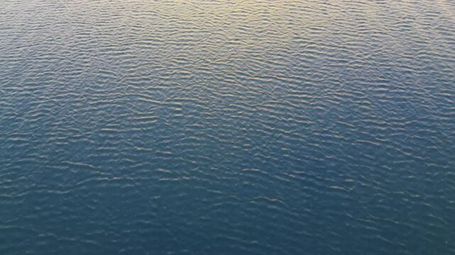 Aerial Drone View of Peaceful Coastal Sunset with Calm Ocean Landscape