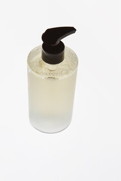 Angled floating shower gel bottle on white