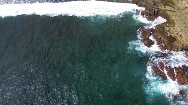 Top Down Aerial Drone View of Ocean Waves Crashing on Sandy Beach