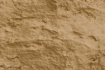 Naklejka premium a rough sandstone cliff wall featuring a rich earthy texture. The surface is characterized by irregular crevices, grainy details, and eroded patterns in warm ochre, beige, and tan tones