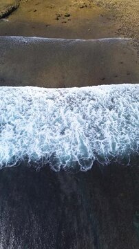 Top Down Aerial Drone View of Ocean Waves Crashing on Sandy Beach